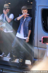 组图：比伯当街献唱谢歌迷 小天王自恋摸发