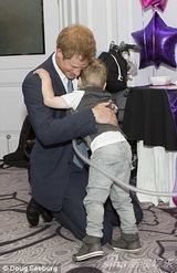 组图：哈里王子双膝着地拥抱4岁重病男童