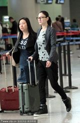 组图：李小冉现身机场 强颜欢笑助理挡镜头