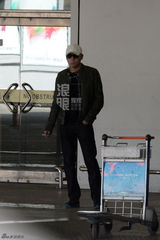 组图：刘烨墨镜遮面机场抽烟 刷微博手机不离手