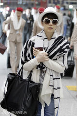 组图：海清现身机场心情大好潮范儿十足