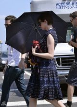 组图：安妮海瑟薇撑破伞拍新片 雪纺裙腹部微隆
