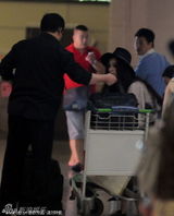 组图：范冰冰烟熏妆亮相机场 亲自蹲地整理行李 