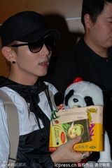 组图：李准基现身机场遭围堵 熊猫公仔遮面调皮卖萌