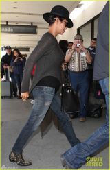 组图：哈莉贝瑞手遮孕肚面带微笑现身机场