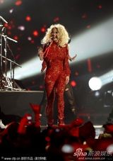 组图：Rita Ora撑黑伞演出 红色蕾丝连身裤秀身段