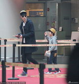 组图：张亮携妻儿现身机场 天天坐行李车可爱