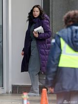 组图：劳伦斯披紫袄现身片场 素颜显知性气质