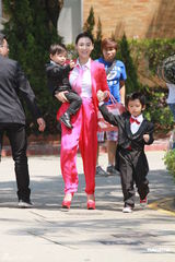 组图：张柏芝喜气红衣携两子参加弟弟婚礼