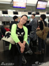 组图：王菲素颜现身机场 路人合影淡定当背景板