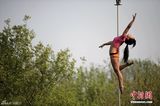 组图：钢管舞国家队秀高难度技巧 户外“悬浮”