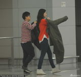 组图：李嘉欣橘衫现身机场抢眼 寒流来袭忙加衣