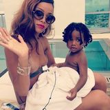 组图：蕾哈娜比基尼与萌犬抢椰子 抱正太显母爱