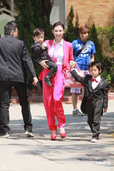 组图：张柏芝喜气红衣携两子参加弟弟婚礼