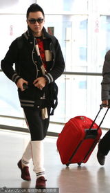 组图：刘璇与老公王弢同抵机场 低头自顾玩手机