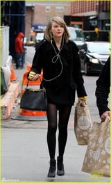 组图：斯威夫特黑丝秀美腿 妆容精致遭路人忽略